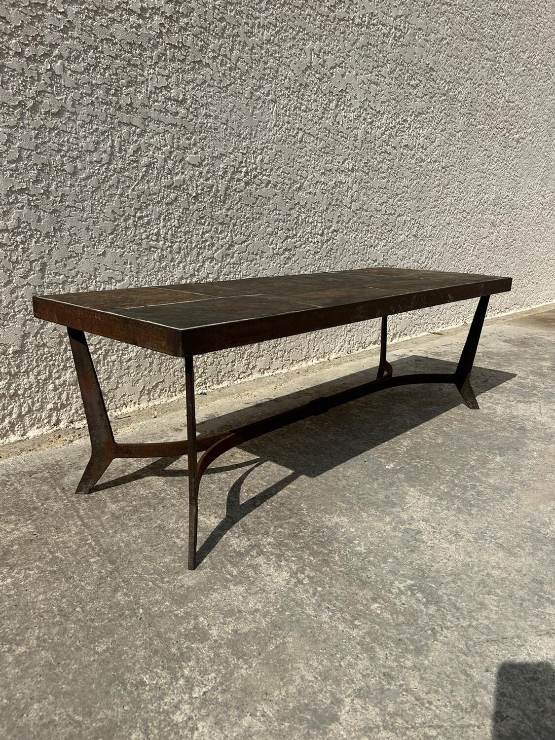 Coffee table with stone top and iron legs