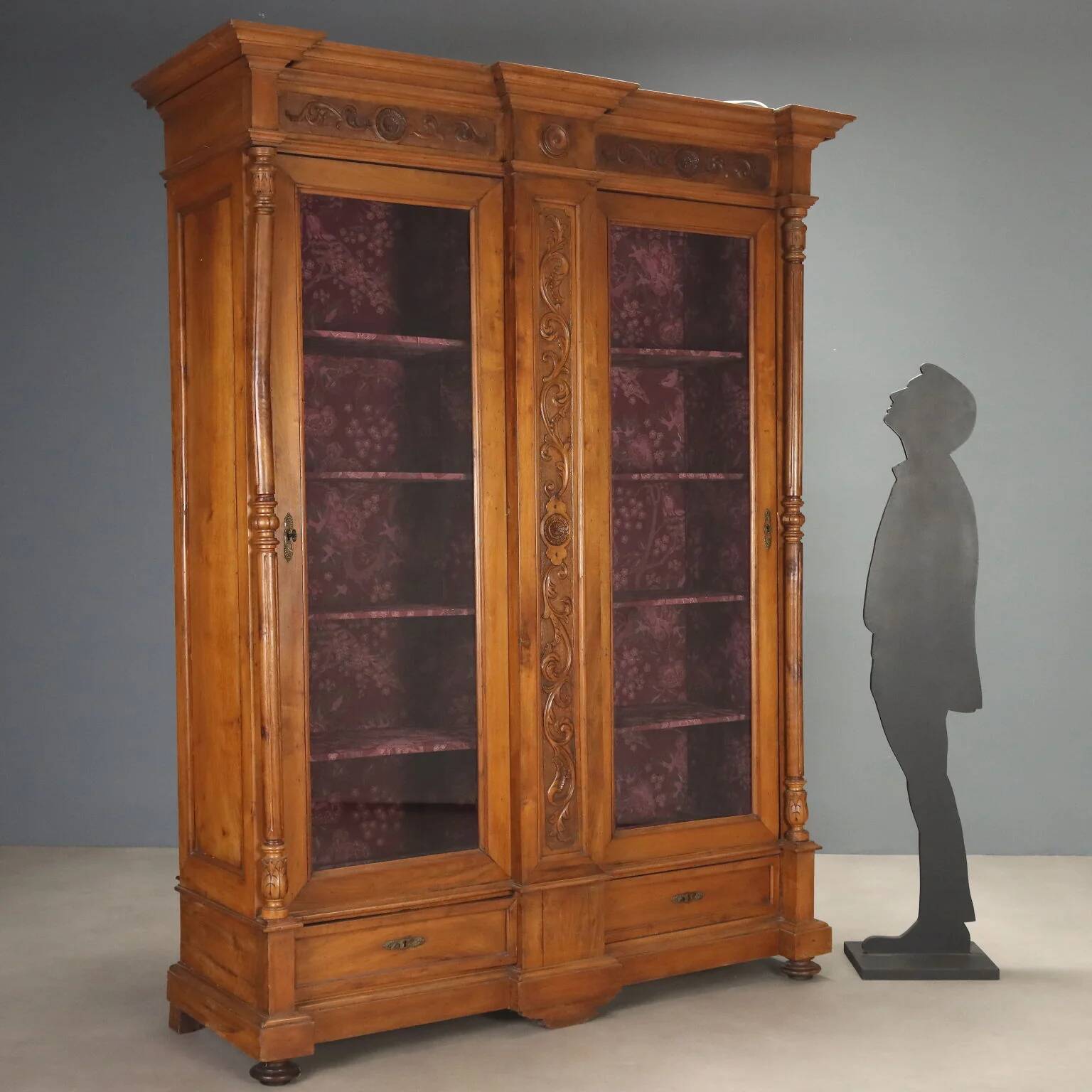 Antique walnut wardrobe with glass and carvings, Italy, 19th century.