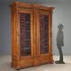 Antique walnut wardrobe with glass and carvings, Italy, 19th century.