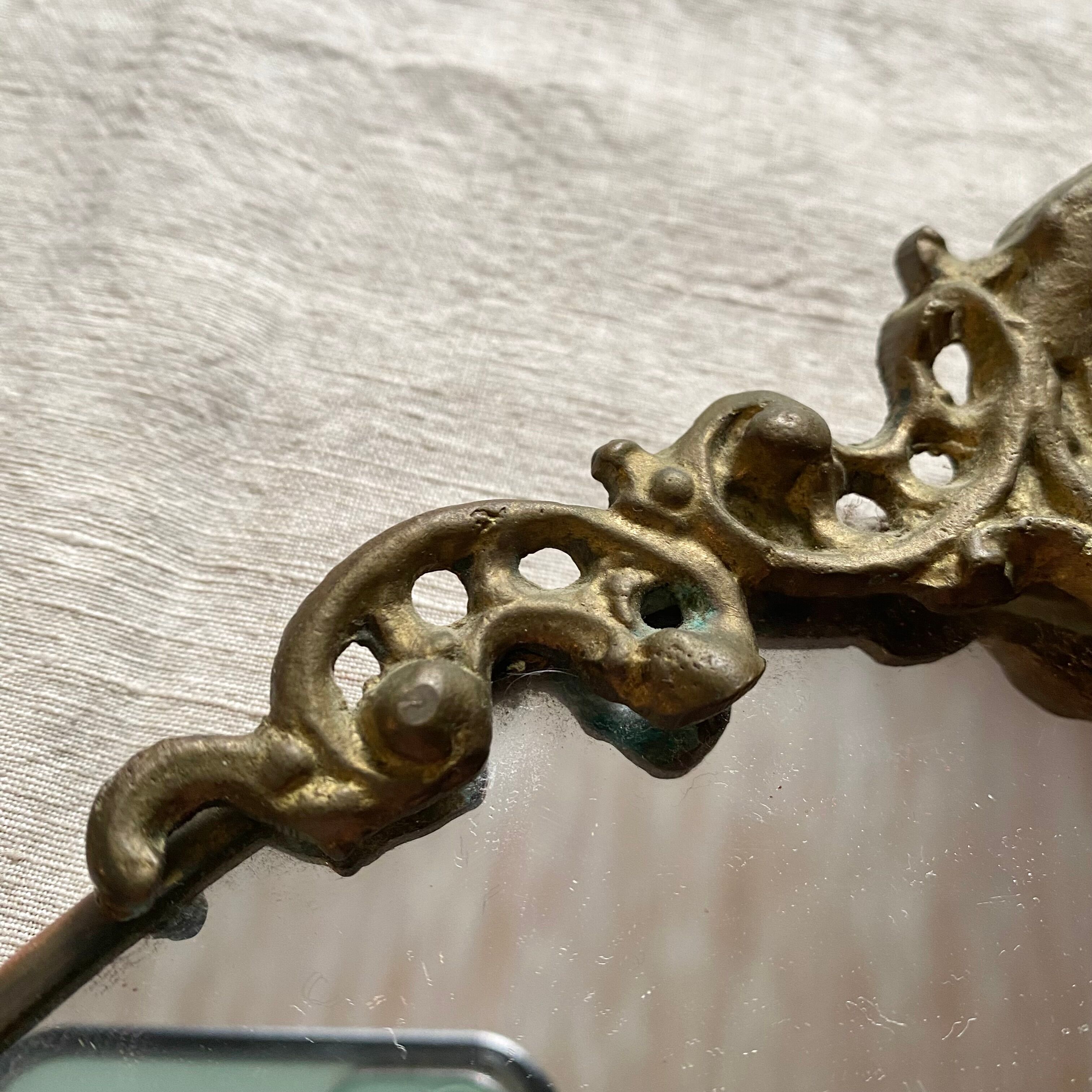 Antique oval brass crest mirror, 41x26 cm