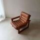 Vintage lounge chair in teak and leather from the 1960s.