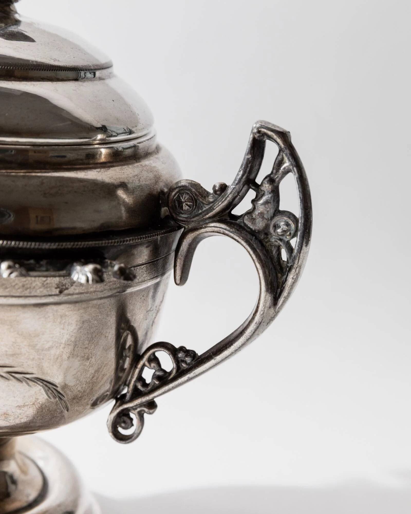 Vintage 1930s silver-plated footed bowl with lid by Warren Rogers New York, featuring a bird motif and ornate details.