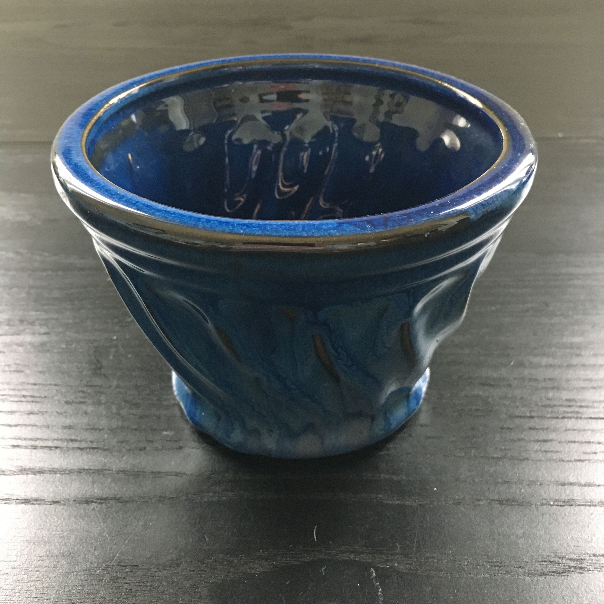 Navy blue stoneware pot.