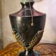 antique patinated cast iron lamp with a glass paste lampshade, showing signs of wear.