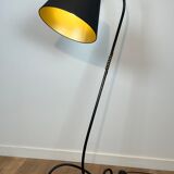 Design floor lamp in black lacquered metal and brass.