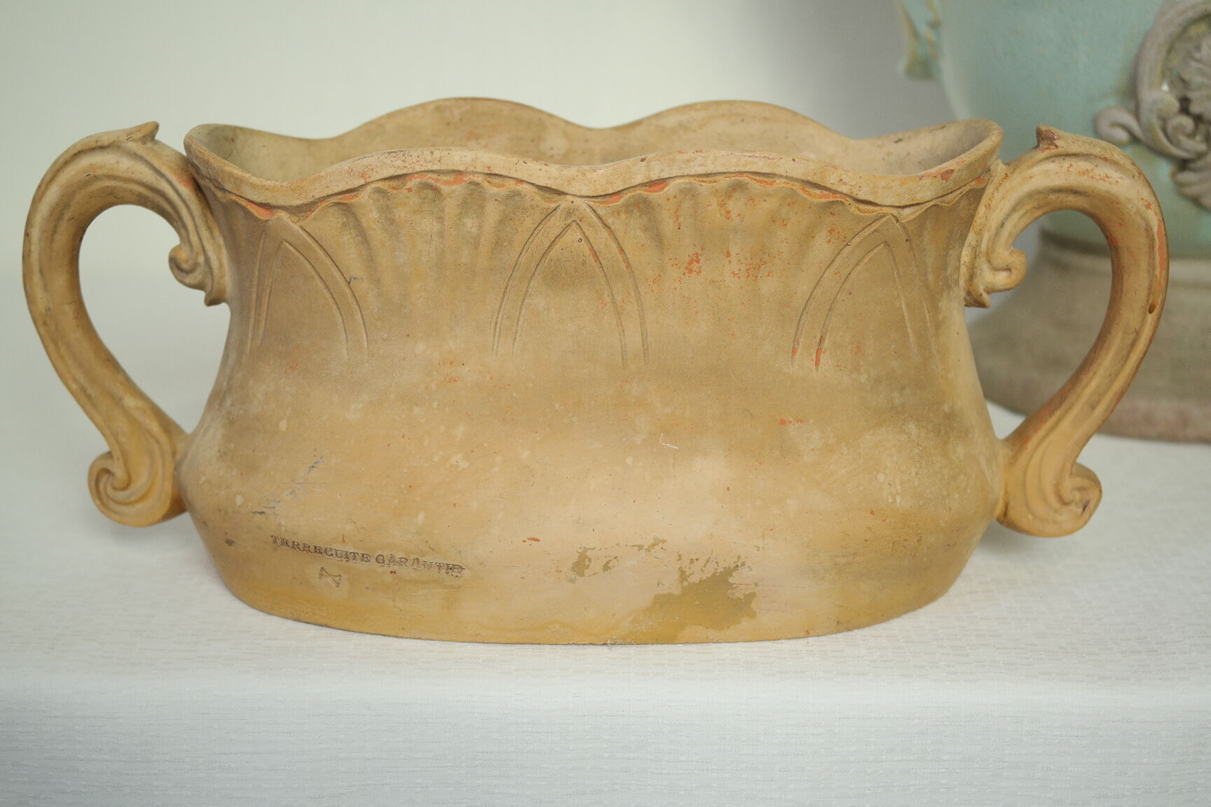 Art Nouveau jardinière with bas-reliefs in terracotta.