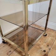 Gold metal and smoked glass serving trolley