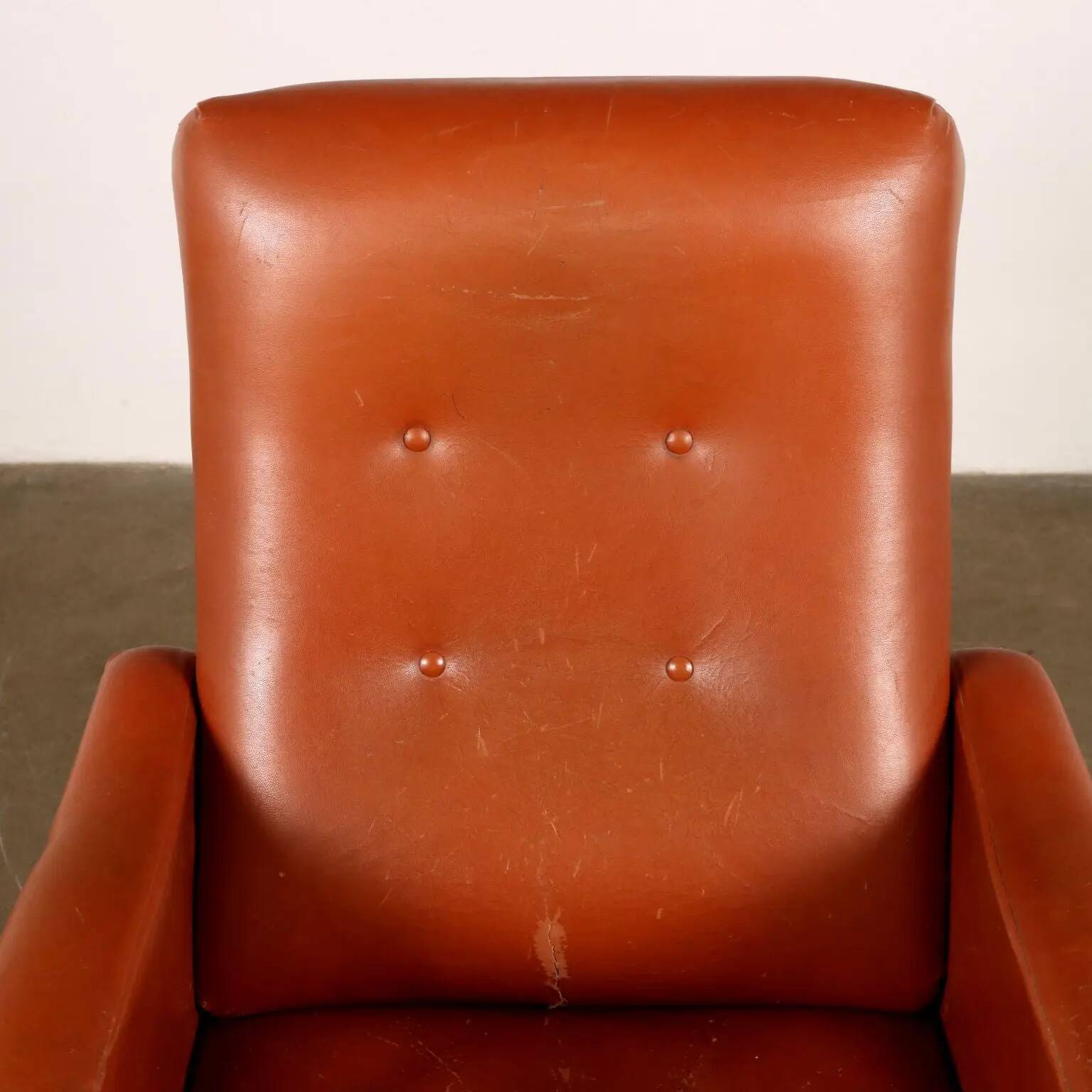 Vintage armchair from the 1970s in foam, faux leather, and metal.