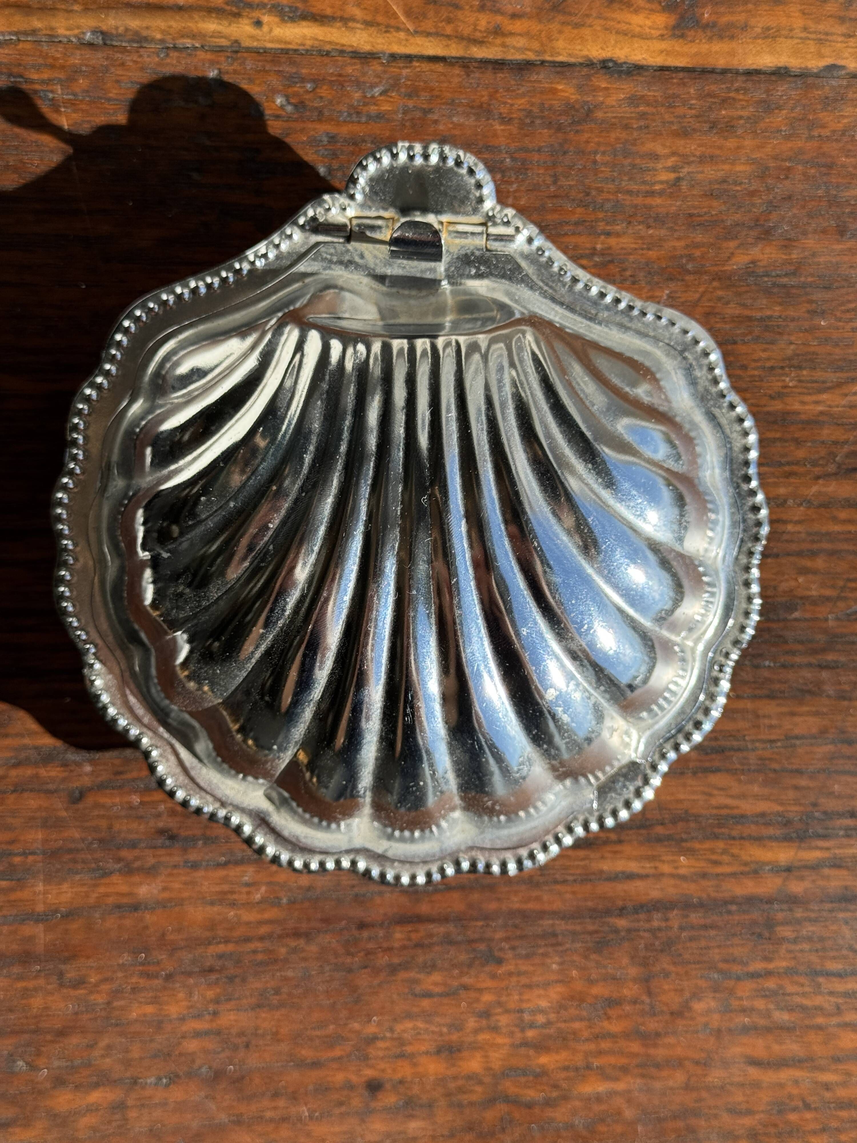 Vintage silver-plated shell butter dish with transparent bowl.