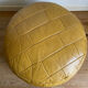 2 poufs moutarde patchwork en cuir de Sède