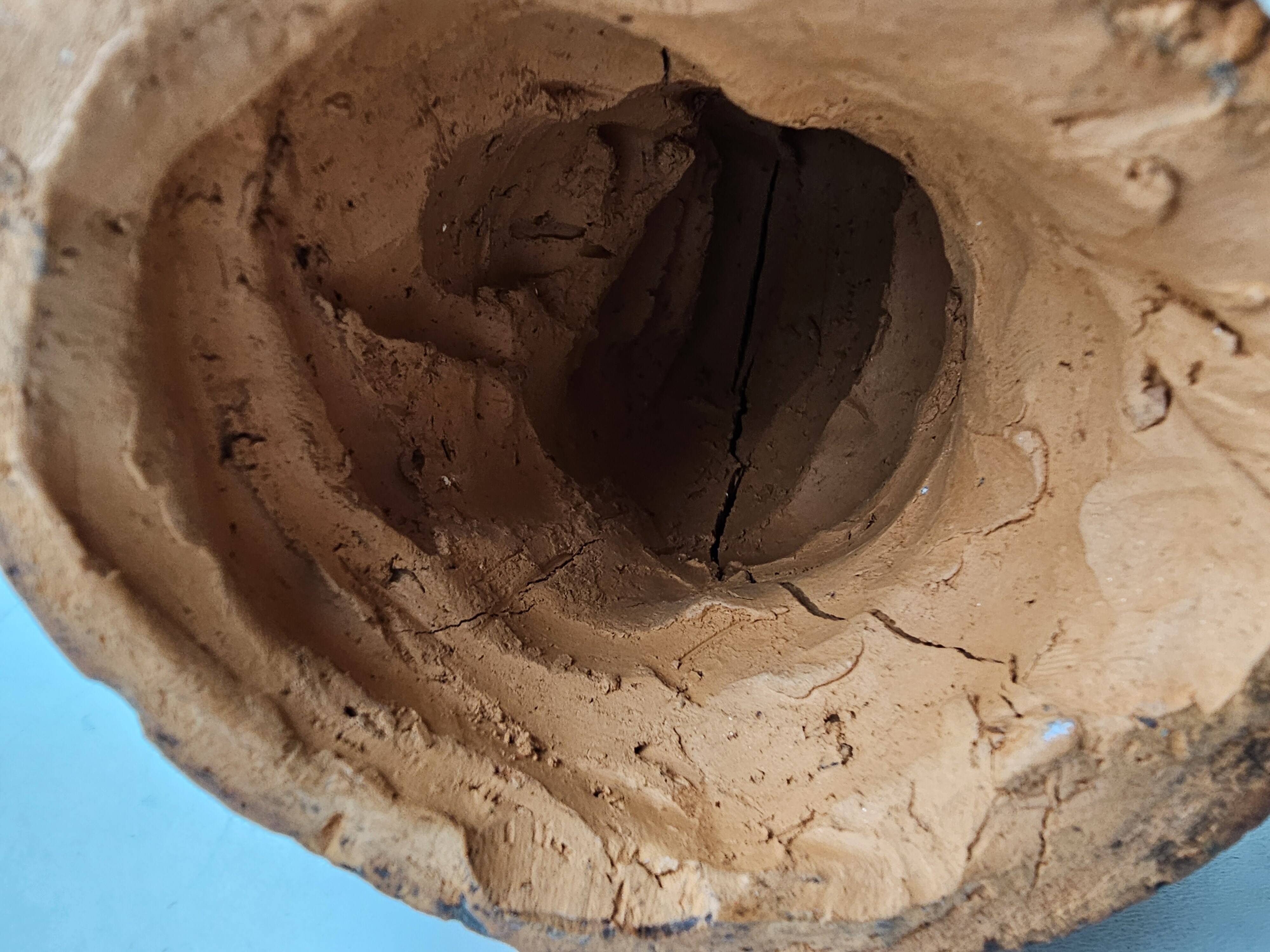 Terracotta face sculpture in African art style