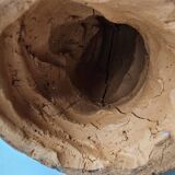 Terracotta face sculpture in African art style