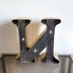 Old letter N of gilded metal sign