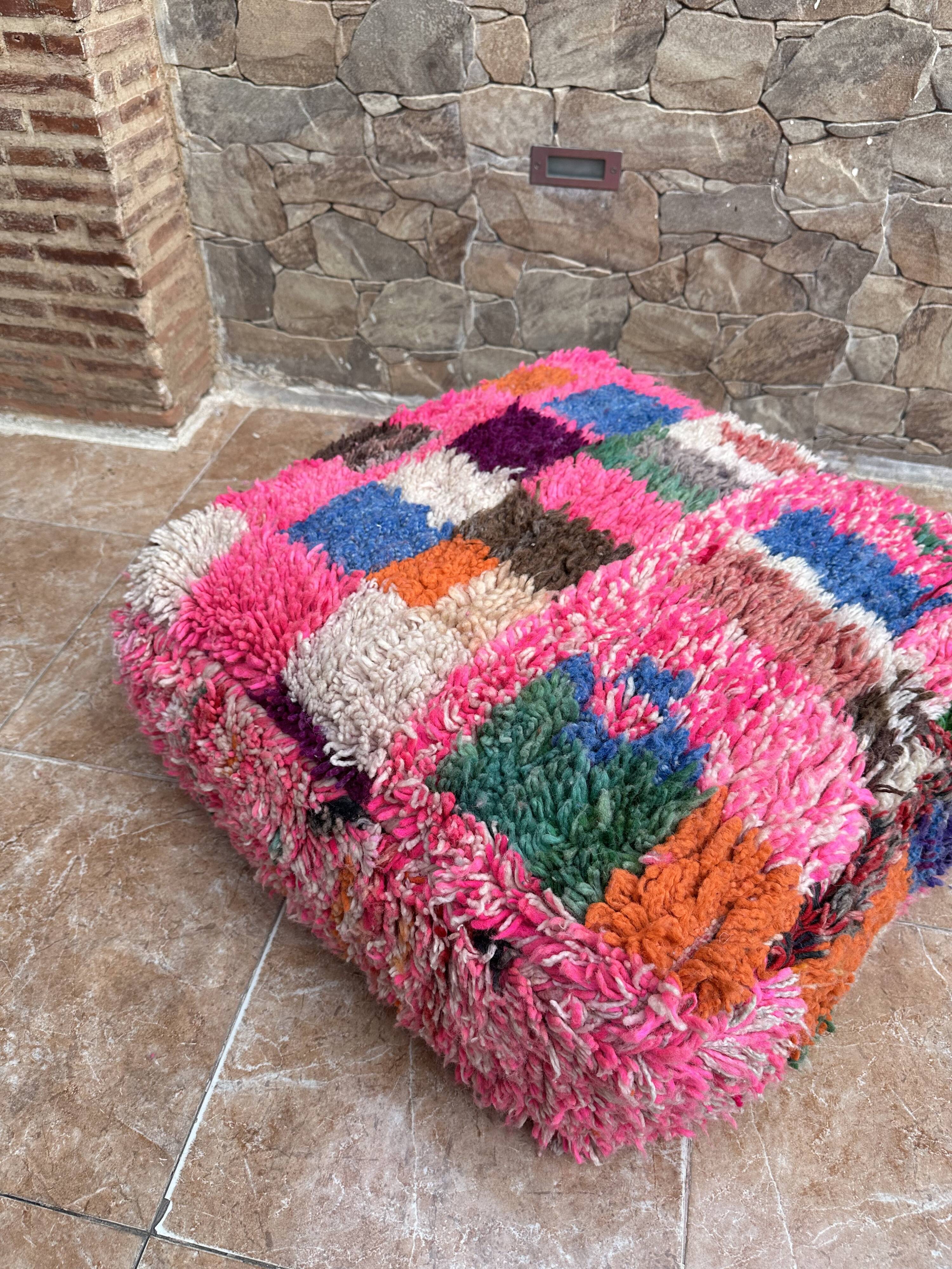 Berber floor pouf: Handwoven Moroccan wool cushion.