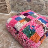 Berber floor pouf: Handwoven Moroccan wool cushion.