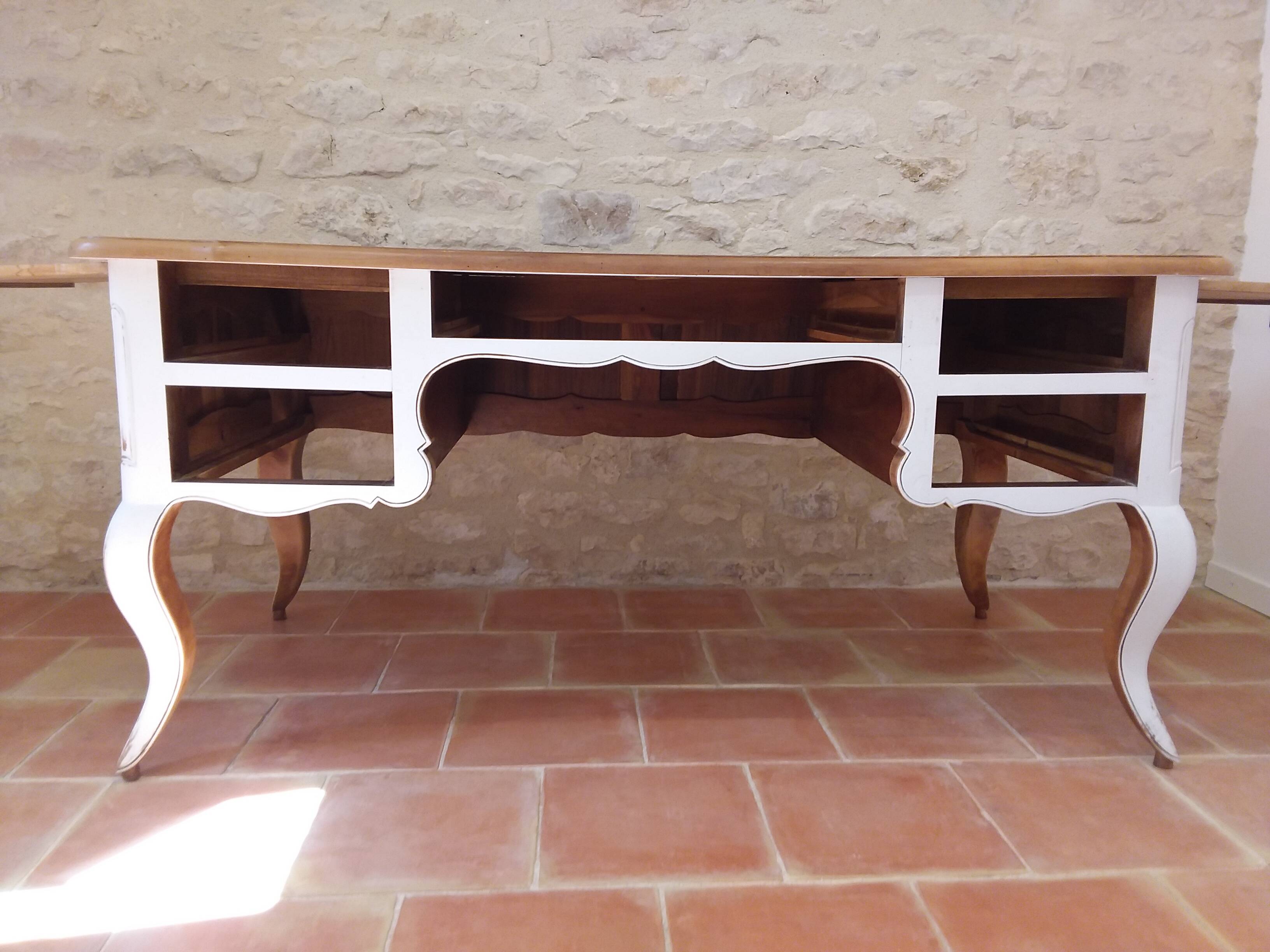 Solid wood desk with distressed white paint.
