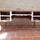 Solid wood desk with distressed white paint.