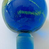Blown blue glass bottle with inclusions