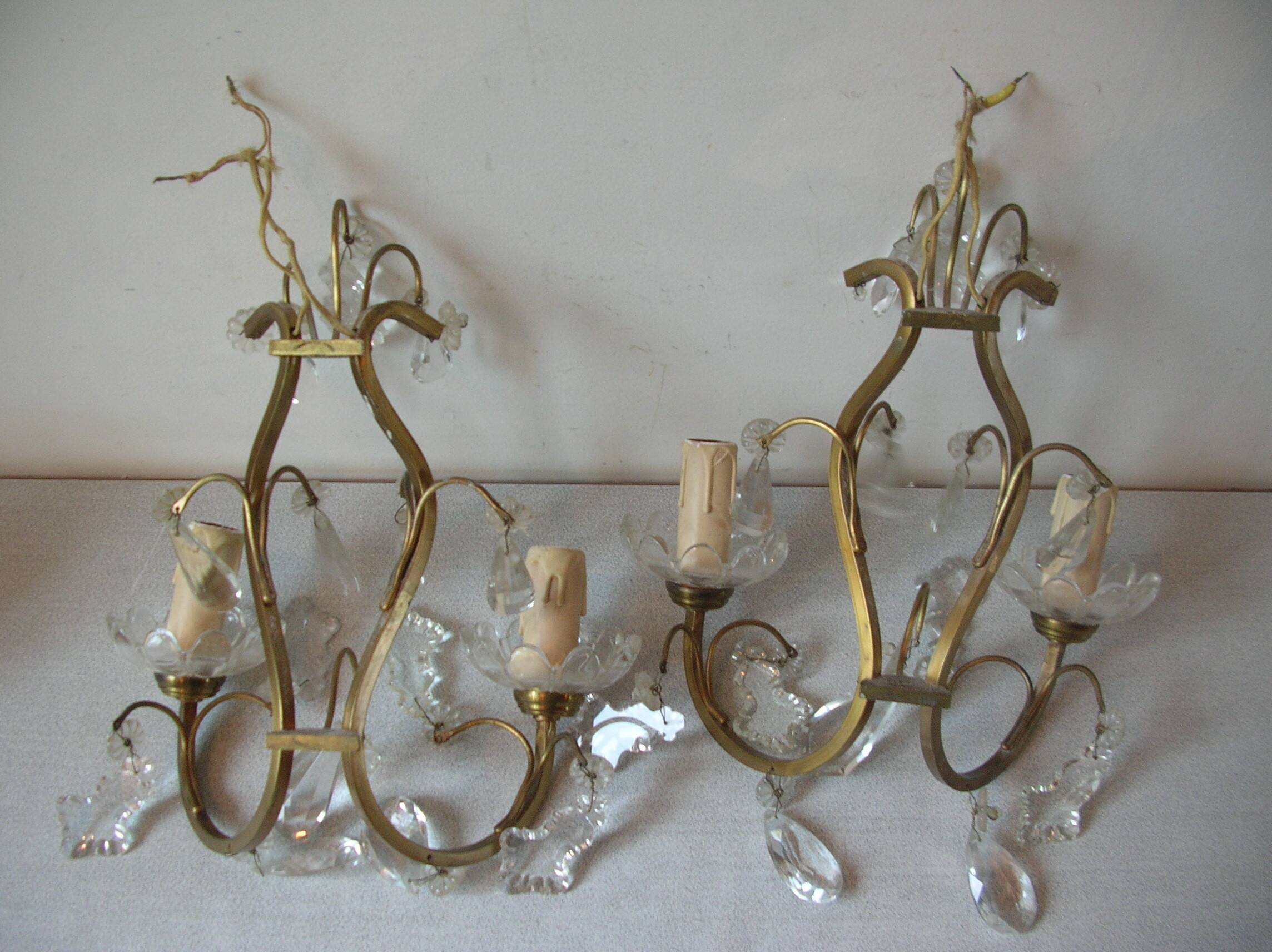 Old pair of double lamp lights with glass and brass pendants, retro decoration