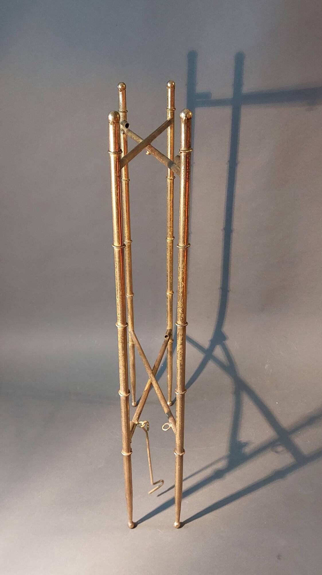 Pedestal table in patinated gilded brass faux foldable bamboo.