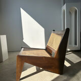 Reclined armchair in canned teak in natural wood