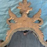 Antique scalloped mirror with pediment decorated with cherubs – carved gilded wood