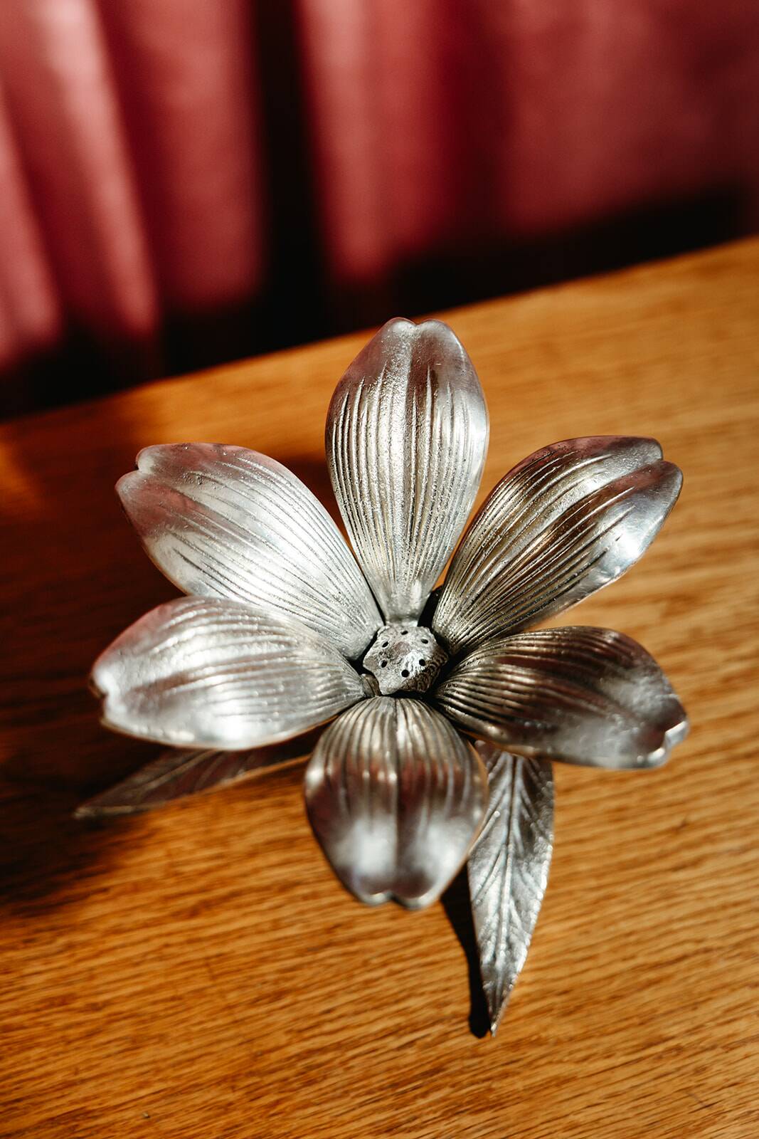 Vintage brass flower ashtray with removable petals.