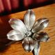 Vintage brass flower ashtray with removable petals.