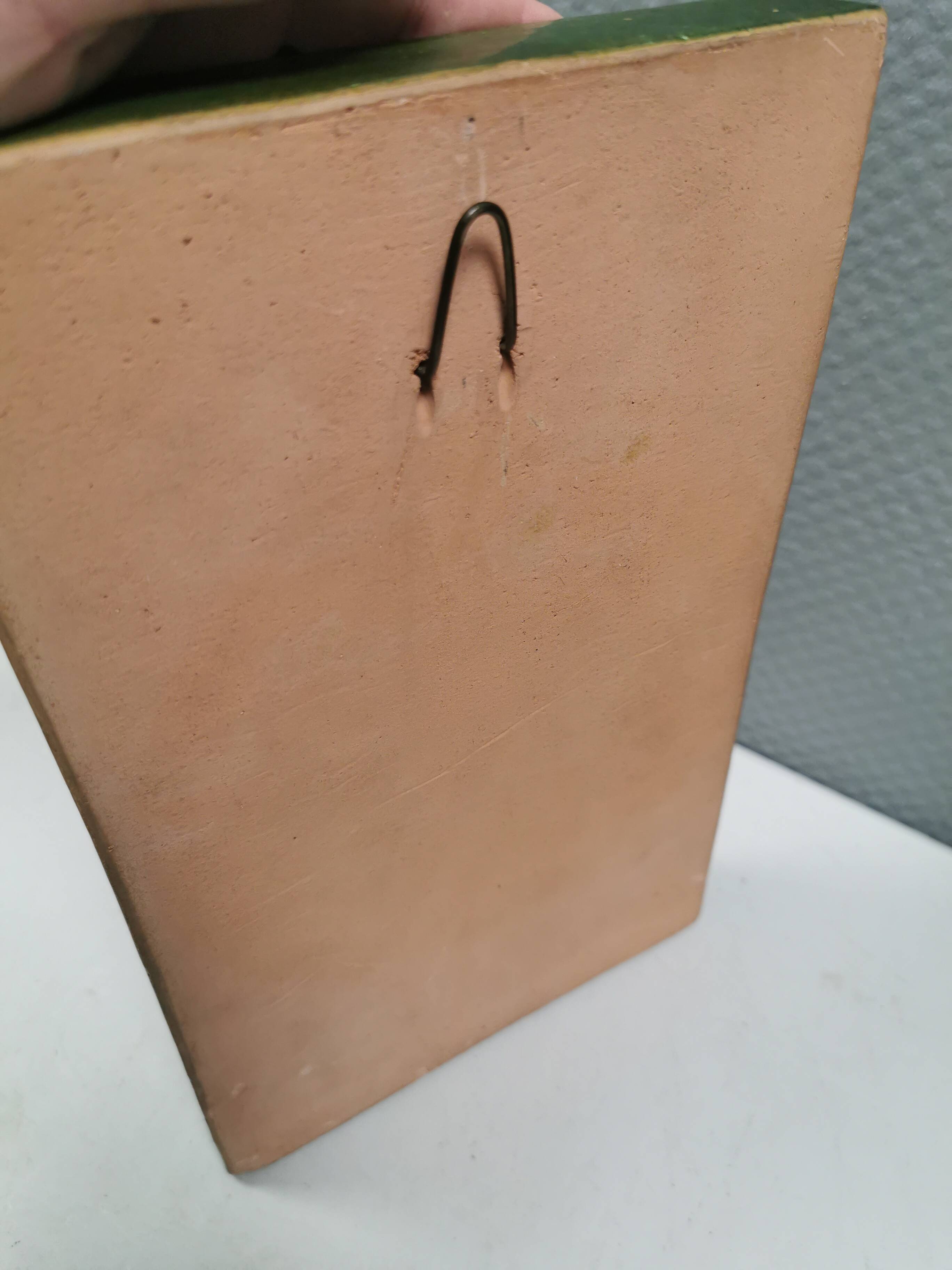 Antique tile in green faience, motif of Saint George and the dragon