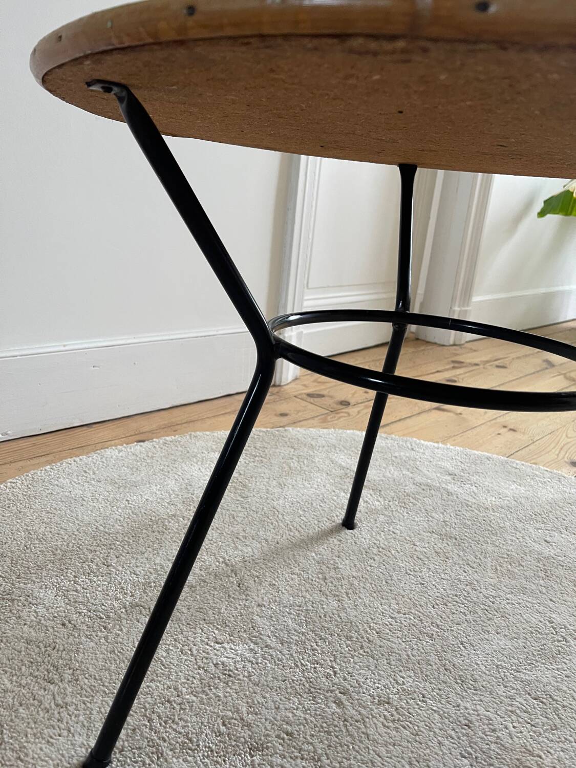Tripod coffee table with a straw covering.