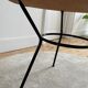 Tripod coffee table with a straw covering.