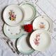 Flat antique earthenware plates with gilded edges
