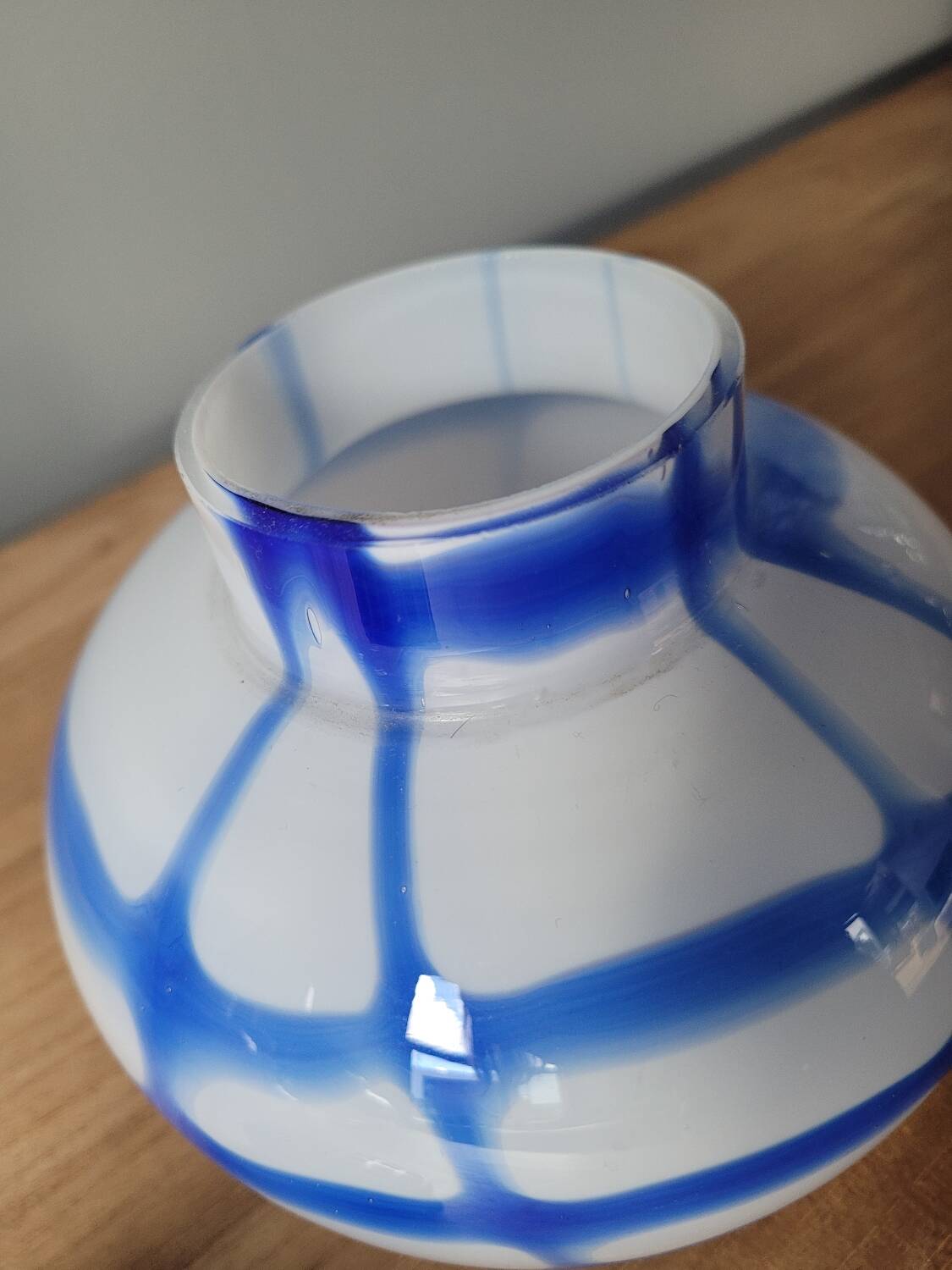 Old white and blue glass flower vase