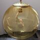 Old large and imposing thick glass globe with a bubbled amber colour, vintage.