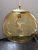 Old large and imposing thick glass globe with a bubbled amber colour, vintage.