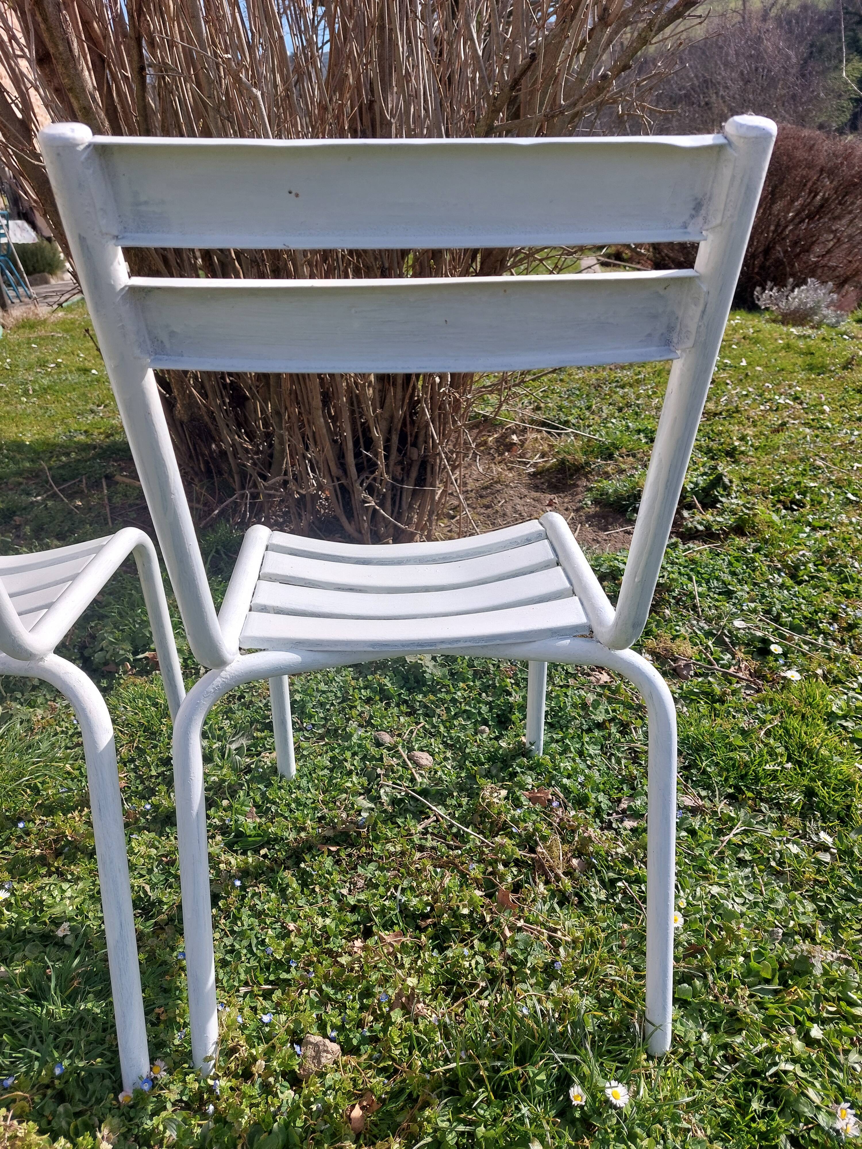 pair of white metal chairs, Tolix style
