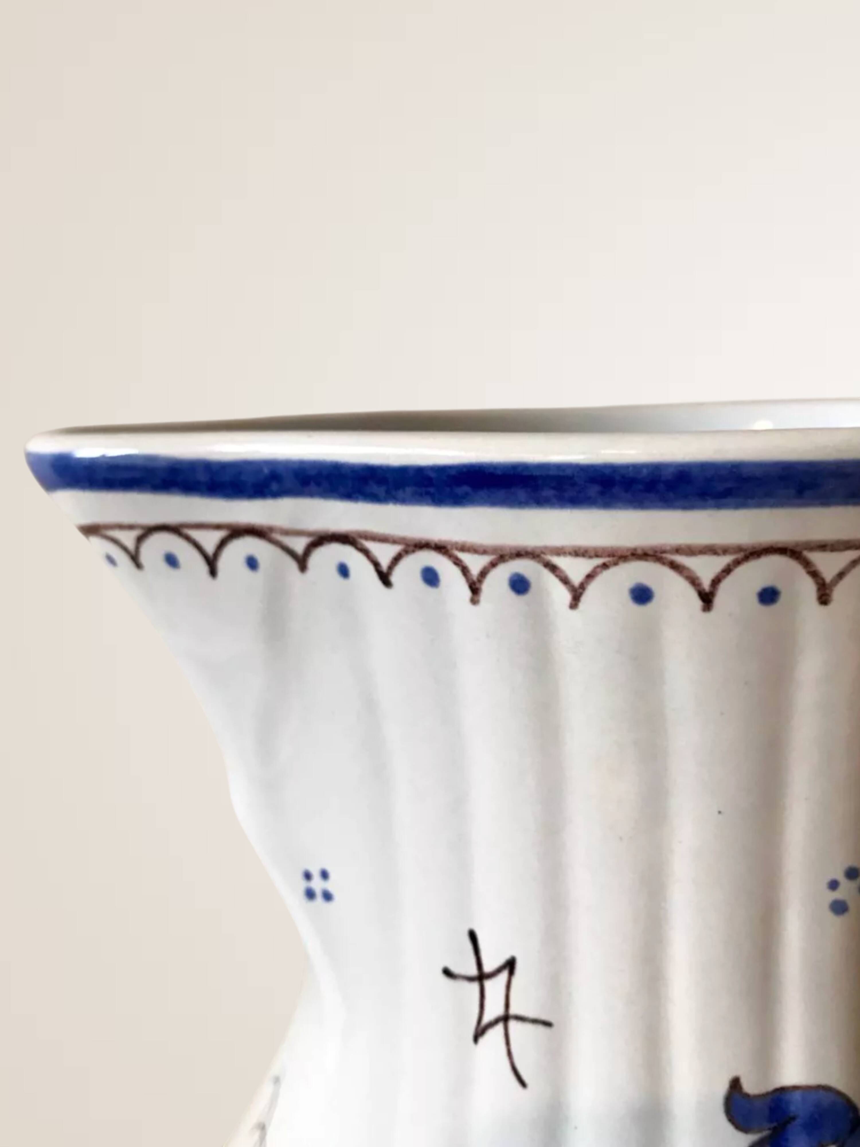 Moutiers earthenware jug, hand-painted blue decoration.