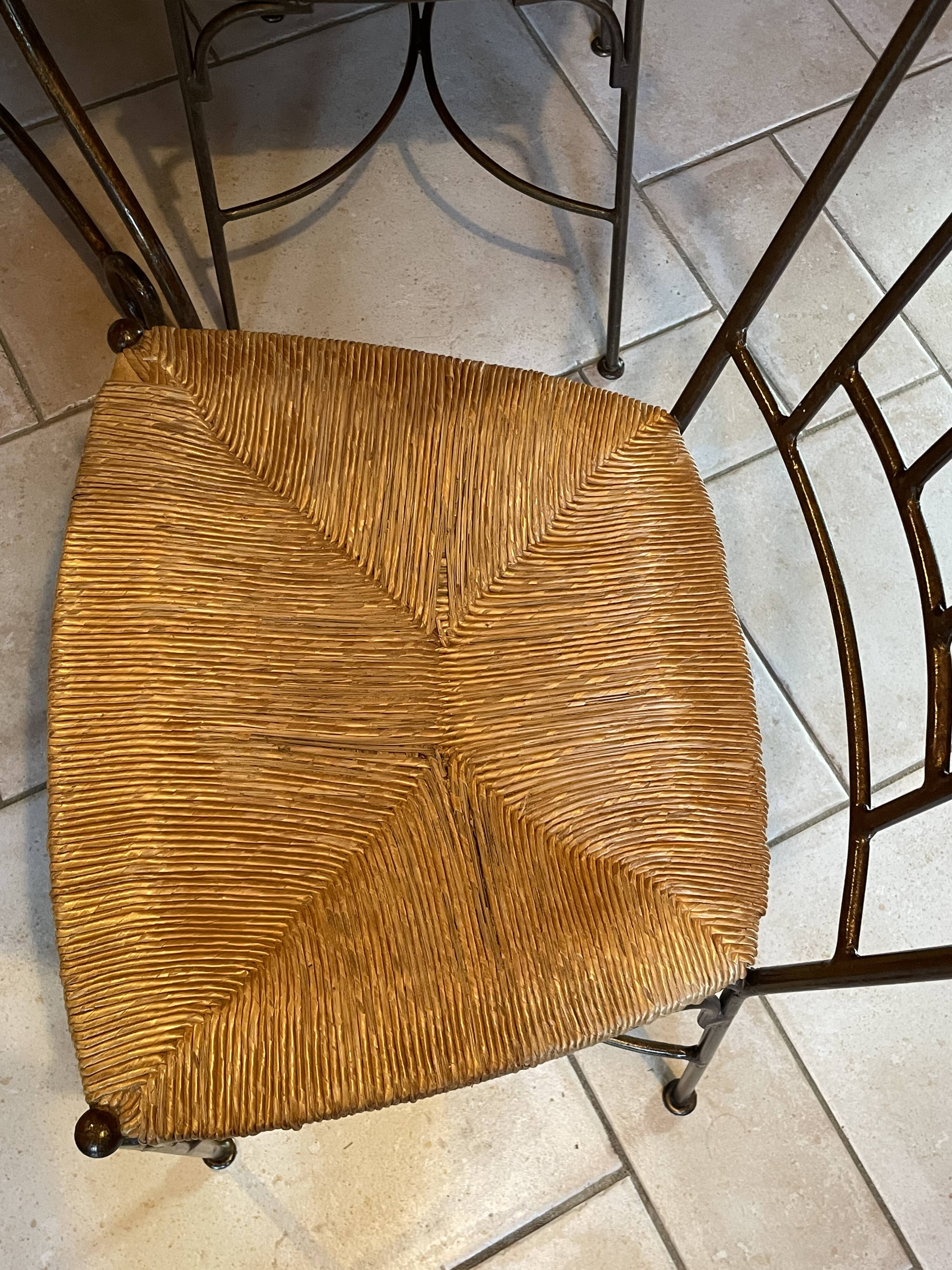 Table and four wrought iron and wood chairs.