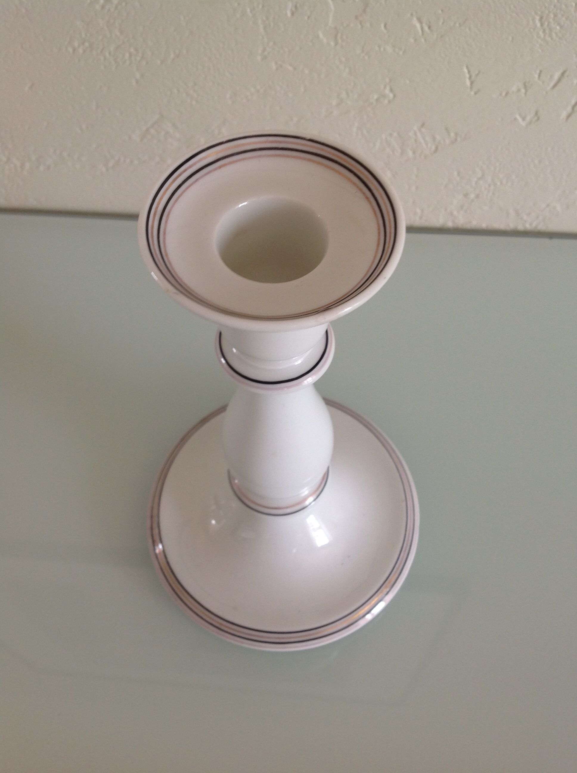 Old white earthenware candlestick