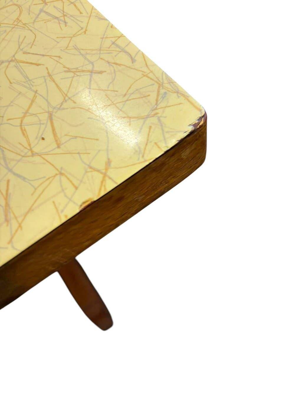 Vintage wooden table with a yellow formica top.