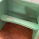 Vintage wooden footrest in mint green.