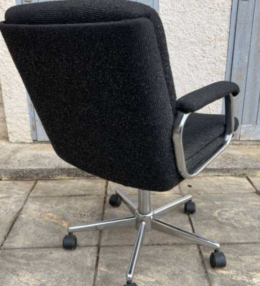 Black mottled fabric and chrome swivel armchair, 1