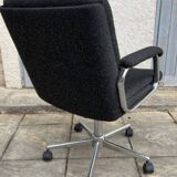 Black mottled fabric and chrome swivel armchair, 1