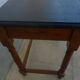 Nightstand or side table in solid wood with a black top.
