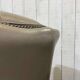 Pair of high-backed Chesterfield armchairs with 1 leather footrest