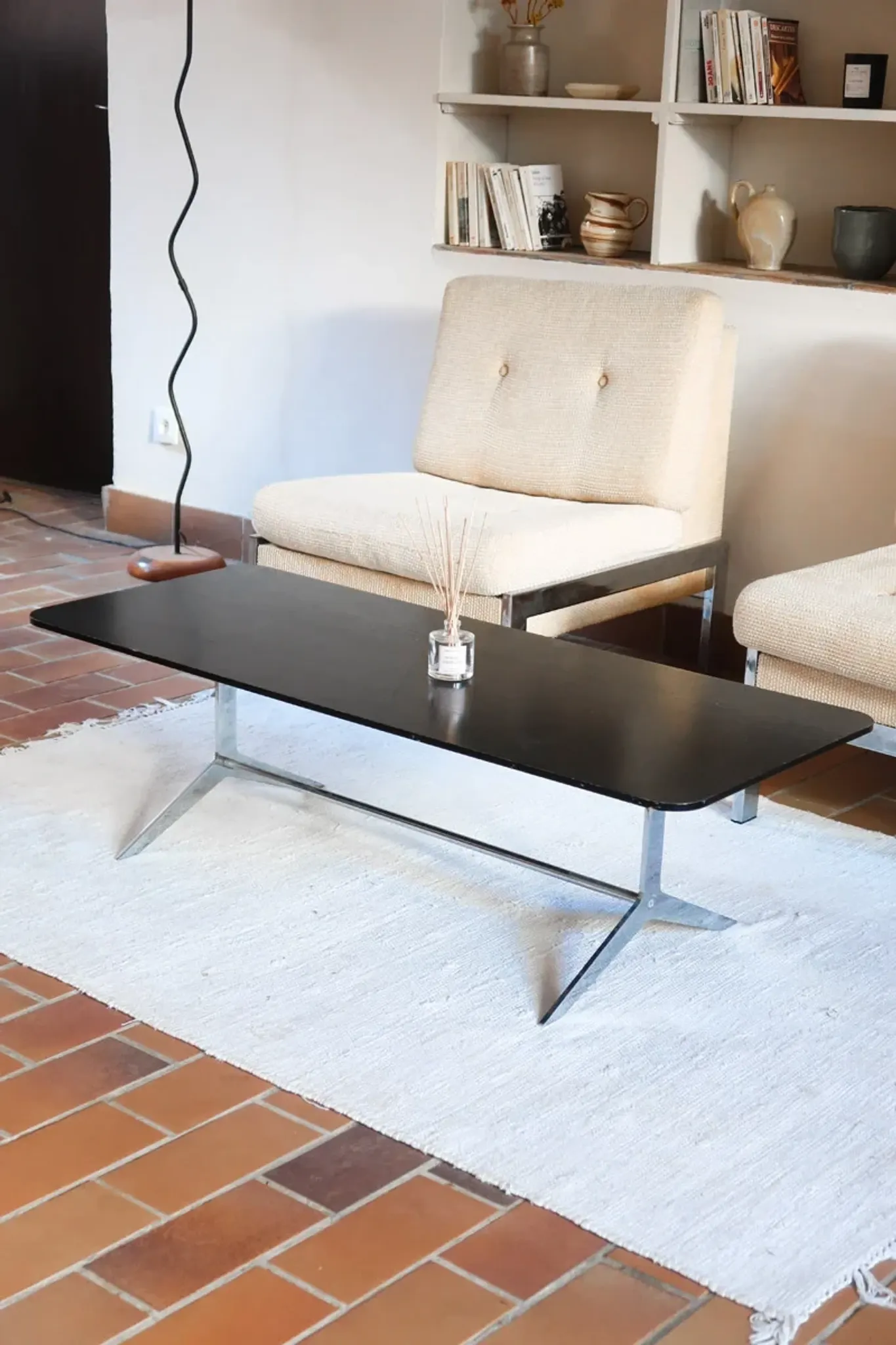 70s design coffee table with a black top and steel legs.