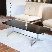 70s design coffee table with a black top and steel legs.