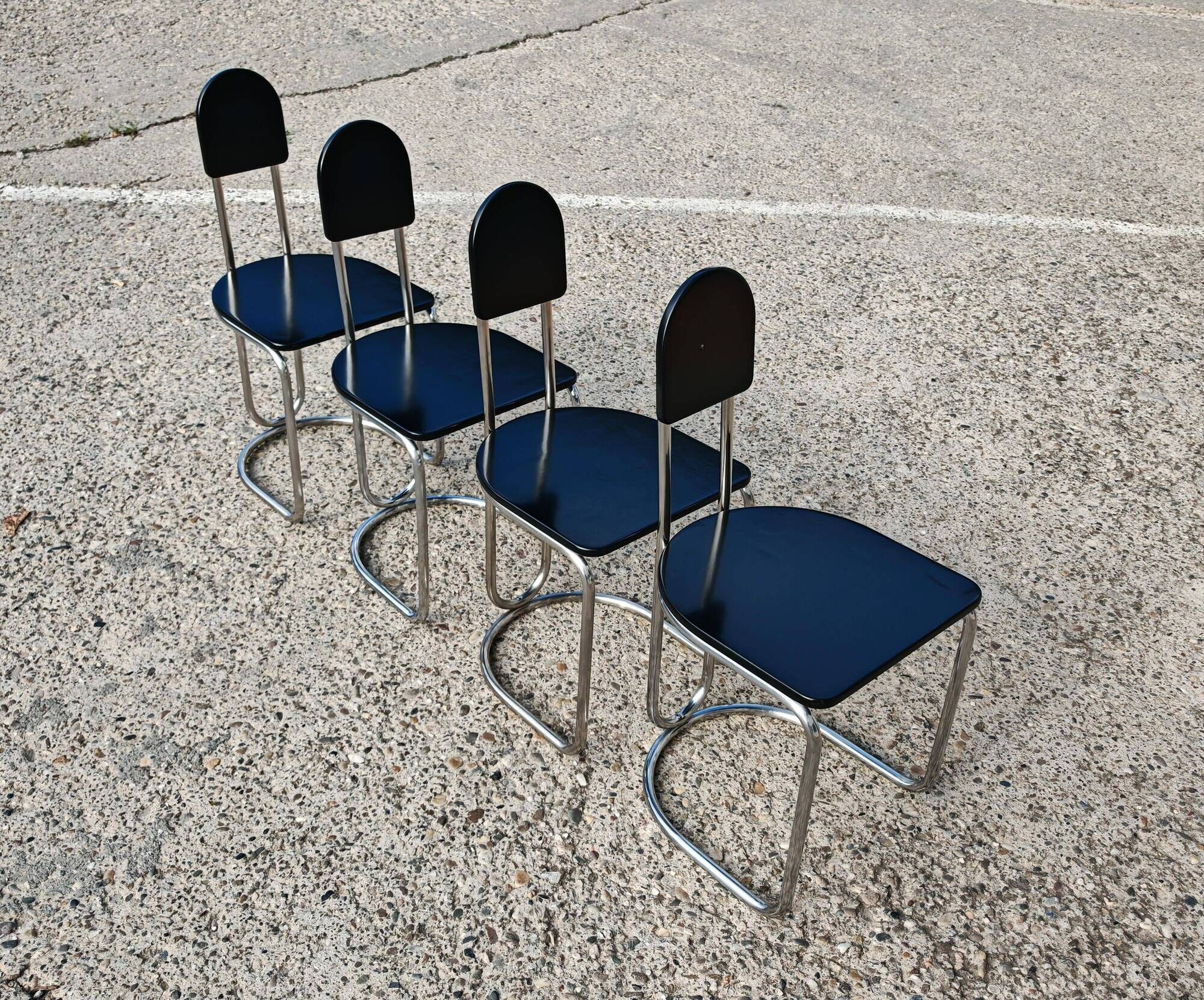 Set of 4 Bauhaus tubular steel chairs with wooden seats.