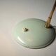 Adjustable table lamp in patinated brass and green metal