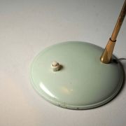 Adjustable table lamp in patinated brass and green metal